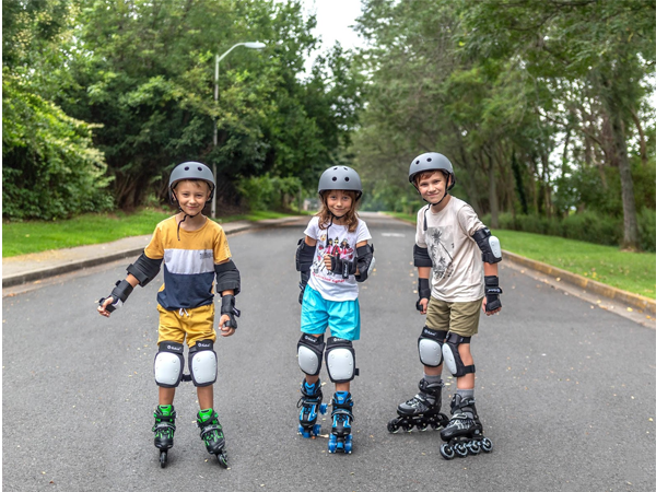 Kids wearing adjustable roller skates.